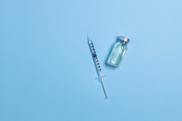 Vial with coronavirus vaccine and syringe