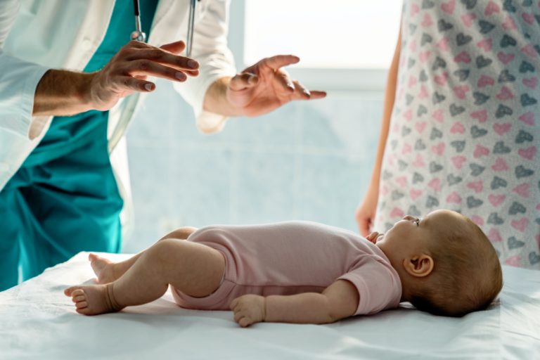 Pediatrician examines a baby in hospital. Healthcare child concept